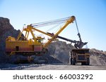 stock-photo-loading-the-gold-ore-into-heavy-dump-truck-at-the-opencast-mining-66003292.jpg