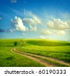 stock photo : Summer landscape with green grass, road and clouds
