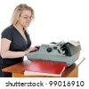 stock photo : Young woman in eyeglasses with old typewriter.