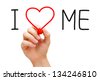 Hand writing I Love Me with red marker on transparent wipe board. - stock photo