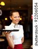http://thumb10.shutterstock.com/thumb_small/461077/461077,1326000092,1/stock-photo-portrait-of-young-waitress-in-white-blouse-holding-a-tray-92206054.jpg
