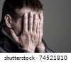 stock-photo-exhausted-sad-businessman-covering-his-face-by-hands-74521810.jpg