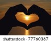Heart shaped hands sunset