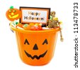 Halloween candy holder full of candy with Happy Halloween tag over white - stock photo