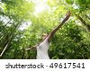 stock photo : Enjoying the nature. Young woman arms raised enjoying the fresh air in green forest.