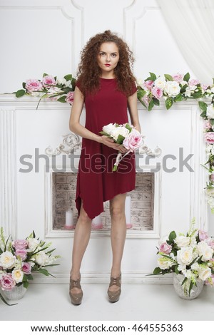 https://thumb10.shutterstock.com/display_pic_with_logo/1139609/464555363/stock-photo-girl-in-a-red-dress-standing-by-the-fireplace-with-a-bouquet-of-flowers-in-their-hands-464555363.jpg
