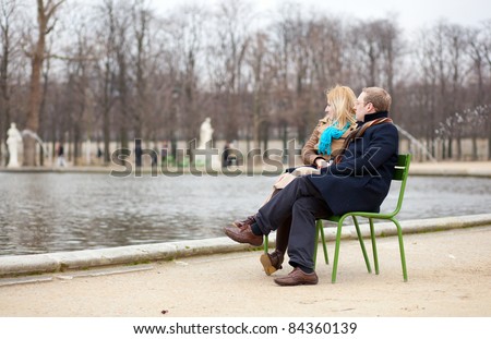 https://thumb10.shutterstock.com/display_pic_with_logo/118180/118180,1315650931,3/stock-photo-couple-in-paris-sitting-in-the-tuilleries-park-84360139.jpg