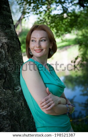 https://thumb10.shutterstock.com/display_pic_with_logo/1333207/198521387/stock-photo-middle-aged-woman-walks-in-the-park-in-the-summer-of-the-tree-198521387.jpg