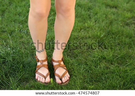 female legs tattoos on green grass stock photo 474574846 female legs tattoos on green grass stock photo 474574846