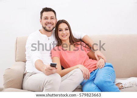 https://thumb10.shutterstock.com/display_pic_with_logo/137002/579823663/stock-photo-young-couple-watching-tv-at-home-579823663.jpg