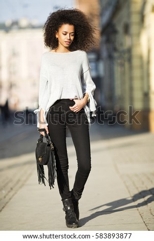 https://thumb10.shutterstock.com/display_pic_with_logo/1433129/583893877/stock-photo-street-fashion-portrait-of-young-beautiful-african-american-afro-woman-walking-in-the-city-model-583893877.jpg