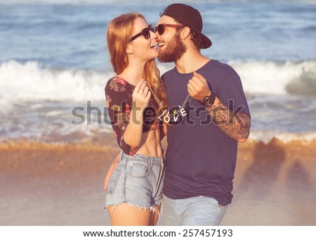 https://thumb10.shutterstock.com/display_pic_with_logo/1767260/257457193/stock-photo-young-couple-in-love-walking-in-the-sea-holding-hands-looking-in-the-sunset-concept-of-valentine-s-257457193.jpg