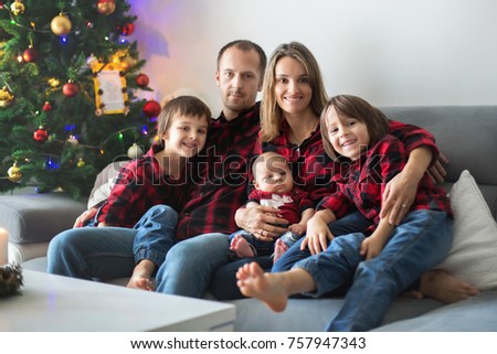 Family Gathered Around Christmas Tree Using Stock Photo 483304177 ...