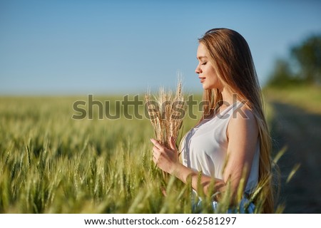 stock photo beautiful happy woman girl smiling outdoors on green wheat field in summer nature pretty woman 662581297