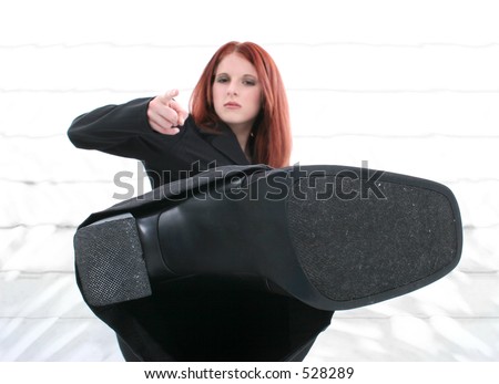 https://thumb10.shutterstock.com/display_pic_with_logo/18/18,1125672367,3/stock-photo-beautiful-angry-young-woman-in-suit-kicking-towards-camera-focus-on-bottom-of-shoe-dirt-and-528289.jpg