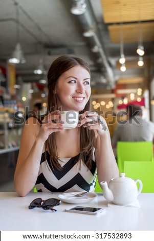 https://thumb10.shutterstock.com/display_pic_with_logo/1813574/317532893/stock-photo-beautiful-girl-in-a-cafe-drinking-tea-coffee-breakfast-in-the-restaurant-looking-out-into-the-317532893.jpg