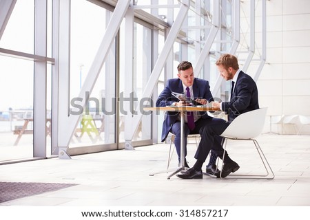 Two business colleagues at meeting in modern office interior