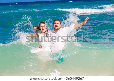 https://thumb10.shutterstock.com/display_pic_with_logo/2200724/360449267/stock-photo-happy-bride-and-groom-having-fun-in-the-waves-on-a-tropical-beach-wedding-and-honeymoon-on-the-360449267.jpg