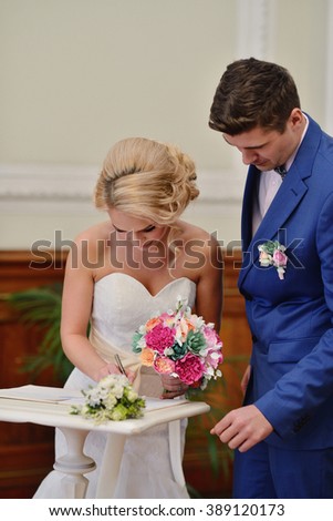 https://thumb10.shutterstock.com/display_pic_with_logo/2302709/389120173/stock-photo-beauty-bride-and-handsome-groom-are-registering-the-marriage-wedding-couple-is-marrying-beautiful-389120173.jpg