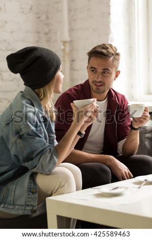 https://thumb10.shutterstock.com/display_pic_with_logo/277009/425589463/stock-photo-young-man-and-woman-sitting-at-modern-cafe-drinking-coffee-425589463.jpg