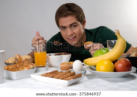 https://thumb10.shutterstock.com/display_pic_with_logo/2787178/375846937/stock-photo-young-man-eating-cereal-and-having-a-healthy-breakfast-375846937.jpg
