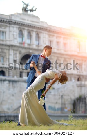 https://thumb10.shutterstock.com/display_pic_with_logo/2810074/304027127/stock-photo-beautiful-young-wedding-couple-of-man-in-blue-suit-and-blond-woman-in-long-white-dress-embracing-304027127.jpg