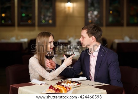 https://thumb10.shutterstock.com/display_pic_with_logo/2811757/424460593/stock-photo-couple-toasting-wineglasses-in-a-luxury-restaurant-424460593.jpg