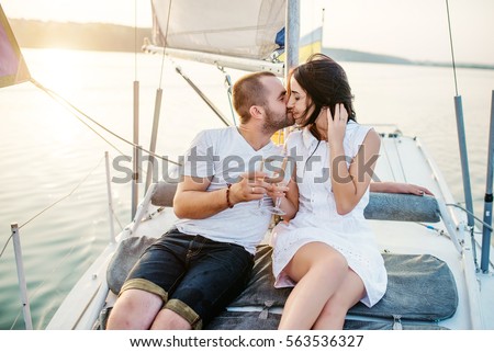 https://thumb10.shutterstock.com/display_pic_with_logo/3026468/563536327/stock-photo-young-beautiful-married-couple-in-love-at-the-yacht-on-vacation-champagne-glasses-on-hands-563536327.jpg