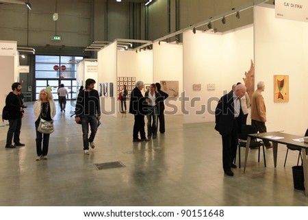 MILAN - APRIL 08: People look at paintings galleries during MiArt, international exhibition of modern and contemporary art on April 08, 2011 in Milan, Italy.