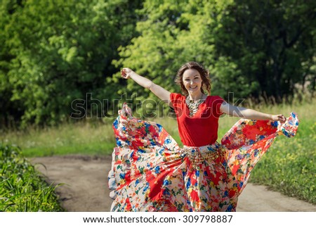 stock-photo-beautiful-gypsy-woman-dancing-in-a-blooming-field-in-a-bright-red-dress-309798887.jpg