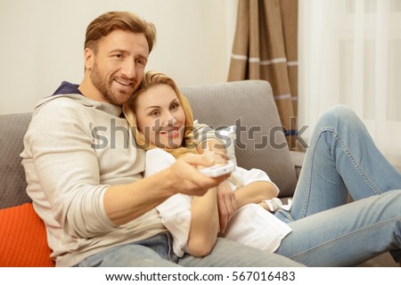 https://thumb10.shutterstock.com/display_pic_with_logo/3437759/567016483/stock-photo-relaxing-at-home-happy-mature-couple-embracing-resting-on-the-sofa-watching-tv-together-using-a-567016483.jpg