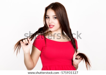 https://thumb10.shutterstock.com/display_pic_with_logo/3486992/575931127/stock-photo-beautiful-young-woman-dressed-in-a-red-dress-holds-pigtails-studio-shot-575931127.jpg
