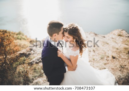 https://thumb10.shutterstock.com/display_pic_with_logo/3823586/708473107/stock-photo-happy-and-romantic-scene-of-just-married-young-wedding-couple-posing-on-beautiful-beach-708473107.jpg