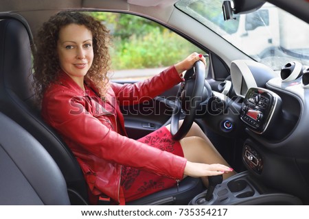 https://thumb10.shutterstock.com/display_pic_with_logo/4225/735354217/stock-photo-beautiful-smiling-curly-woman-in-red-dress-sits-in-car-at-autumn-day-735354217.jpg
