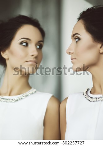https://thumb10.shutterstock.com/display_pic_with_logo/445636/302257727/stock-photo-young-elegant-lady-in-front-of-mirror-soft-focus-302257727.jpg