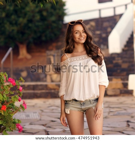 https://thumb10.shutterstock.com/display_pic_with_logo/571009/474951943/stock-photo-young-beautiful-cheerful-woman-walking-on-old-street-at-tropical-town-pretty-girl-looking-at-you-474951943.jpg