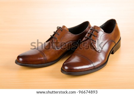 Brown shoes on wooden table - stock photo
