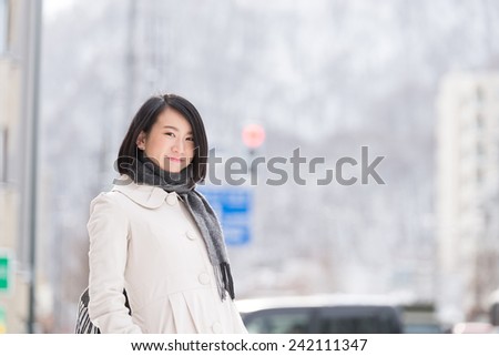 https://thumb10.shutterstock.com/display_pic_with_logo/679093/242111347/stock-photo-young-asian-woman-walking-in-a-winter-city-242111347.jpg