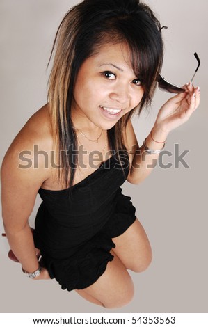 https://thumb10.shutterstock.com/display_pic_with_logo/70209/70209,1275435674,17/stock-photo-a-young-pretty-asian-woman-in-a-short-black-dress-kneeling-on-the-floor-in-the-studio-and-smiling-54353563.jpg