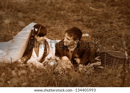 https://thumb10.shutterstock.com/display_pic_with_logo/709168/134405993/stock-photo-retro-black-and-white-photo-of-sepia-bride-and-groom-at-picnic-in-autumn-are-couple-on-green-grass-134405993.jpg