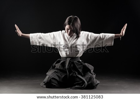 stock-photo-young-beautiful-girl-dressed-in-hakama-practicing-aikido-in-a-dark-gym-381125083.jpg