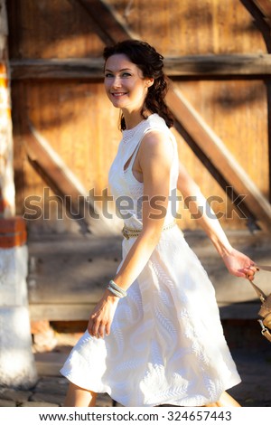 https://thumb10.shutterstock.com/display_pic_with_logo/78982/324657443/stock-photo-beautiful-middle-aged-woman-in-a-summer-dress-with-bag-smiling-and-walking-down-the-street-of-the-324657443.jpg