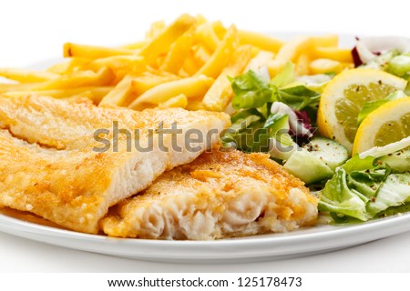 Fish dish - fried fish fillet, French fries with vegetables - stock photo