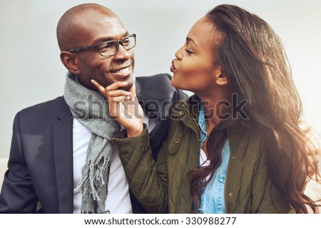 https://thumb10.shutterstock.com/display_pic_with_logo/818215/330988277/stock-photo-coquettish-young-african-american-woman-on-a-date-with-a-handsome-man-playfully-puckering-up-her-330988277.jpg