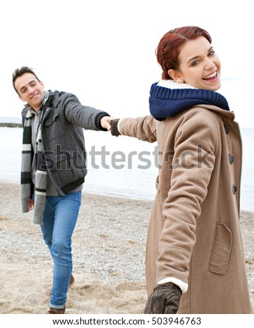 https://thumb10.shutterstock.com/display_pic_with_logo/840583/503946763/stock-photo-portrait-of-beautiful-happy-tourist-couple-playful-holding-hands-on-beach-autumn-winter-holiday-503946763.jpg