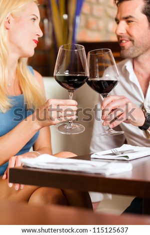 https://thumb10.shutterstock.com/display_pic_with_logo/84610/115125637/stock-photo-attractive-young-couple-drinking-red-wine-in-restaurant-or-bar-it-might-be-the-first-date-115125637.jpg