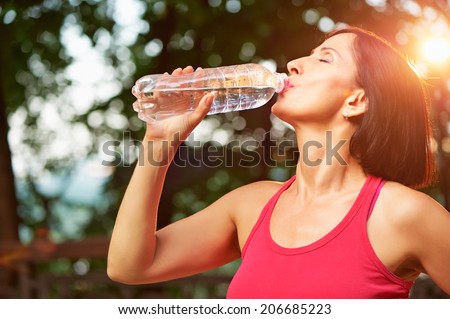 https://thumb10.shutterstock.com/display_pic_with_logo/871054/206685223/stock-photo-senior-athletic-woman-drinks-water-from-a-bottle-after-running-in-the-park-206685223.jpg