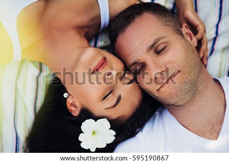 https://thumb10.shutterstock.com/display_pic_with_logo/955855/595190867/stock-photo-top-view-of-a-beautiful-horizontal-portrait-of-a-couple-in-love-lying-on-a-picnic-blanket-happy-595190867.jpg