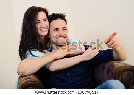 https://thumb10.shutterstock.com/display_pic_with_logo/973984/198990617/stock-photo-happy-and-lovely-young-couple-at-home-in-sofa-watching-tv-together-198990617.jpg